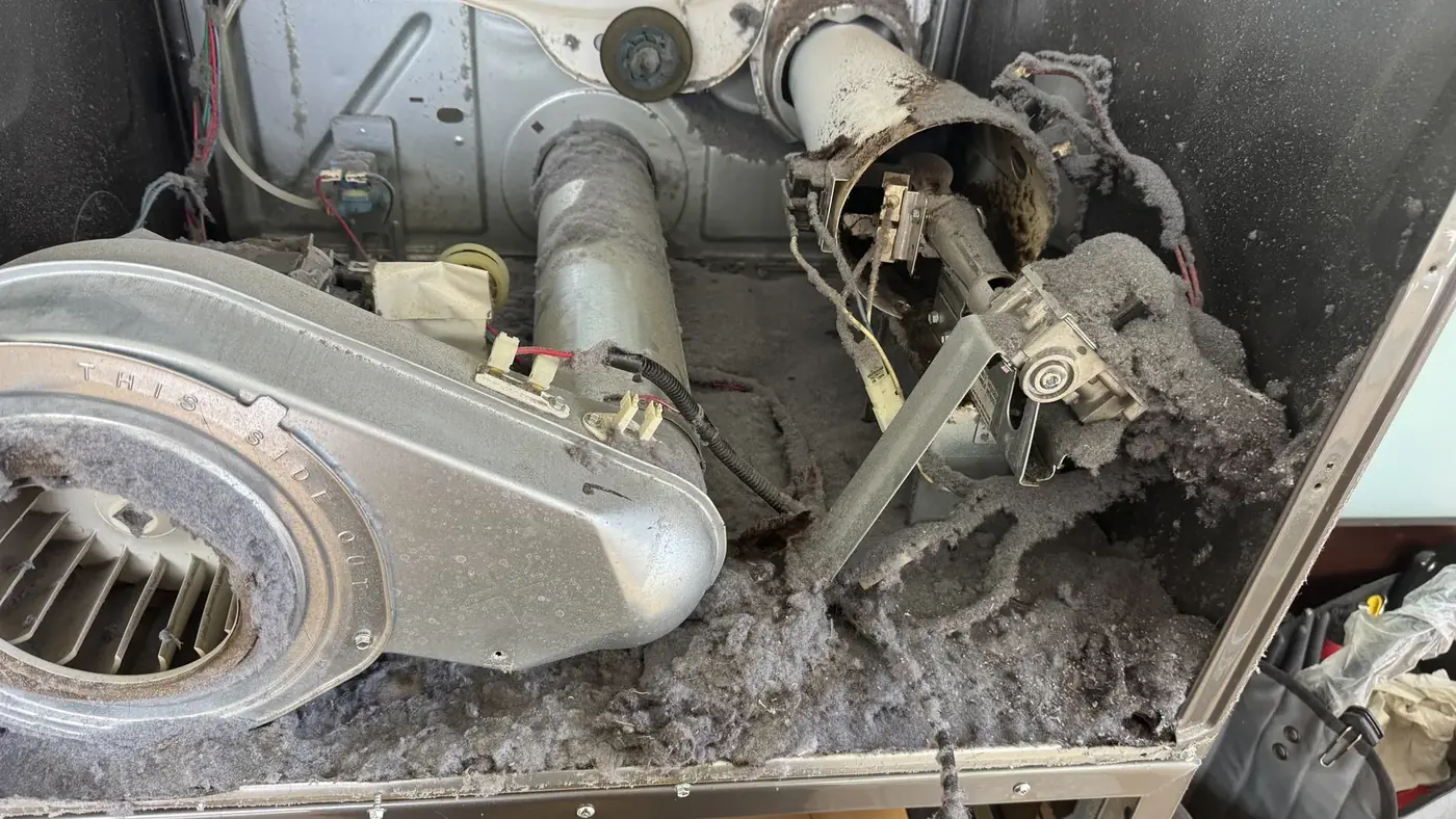 Dryer blower wheel packed with lint